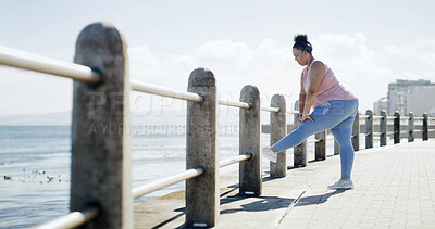 Buy stock photo Stretching, woman and workout for fitness, outdoor or prepare to lose weight with warm up or routine. Beach, plus size and person with headphones in nature, exercise and training legs for wellness