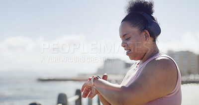 Buy stock photo Plus size woman, smart watch and exercise in city with sky, break and check stats for weight loss by sea. Person, clock and stopwatch on ocean promenade with fitness, training and wellness in Brazil