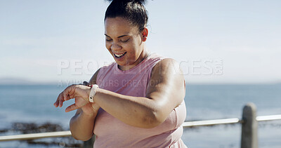 Buy stock photo Woman, smart watch and fitness at beach for health, lose weight and monitor progress for cardio wellbeing. Training workout, plus size runner outdoor and tech for exercise stats, wellness and space