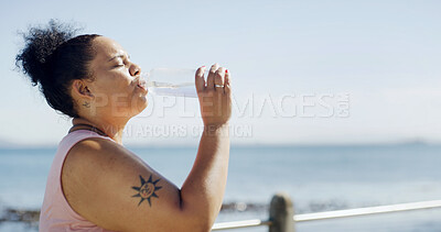 Buy stock photo Woman, plus size or drinking water with beach in fitness for weight loss, diet or healthy nutrition. Tired, female person or thirst with mineral liquid for workout break, rest or hydration on space