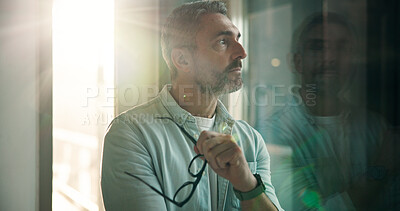 Buy stock photo Professional, man and thinking by window in office for business decision, reflection and insight. Flare, mature person and vision at work for startup company, career development and dream opportunity