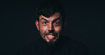 Anger, crisis and portrait of man in studio for psychology, panic and schizophrenia symptoms. Fear, frustrated and mockup space with face of person with bipolar disorder on black background for rage