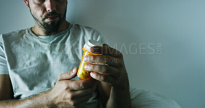 Buy stock photo Man, pills and medication with insomnia for sleep deprivation or disorder in bedroom or home. Male person, hands and reading side effects for symptoms, medical condition or rehabilitation on space