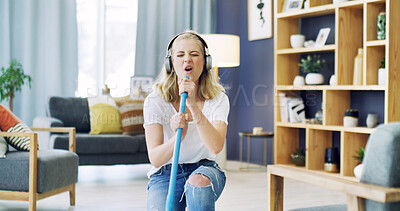 Buy stock photo Home, cleaning and woman with broom, singing and dancing with headphones, song and hygiene. Apartment, radio and person in lounge, music and streaming audio with energy, housekeeping and karaoke