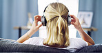 Relax, headphones and back with woman on sofa for streaming service, guided meditation and white noise. Zen radio, subscription and mindfulness with person in living room of home for wellness