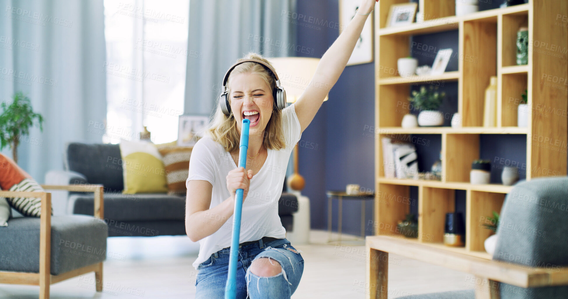 Buy stock photo Woman, broom and singing with cleaning in home, headphones and happy with streaming in living room. Girl, excited and listen to music with audio subscription, performance or dance for chores at house