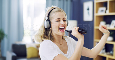 Buy stock photo Karaoke, hair brush and dance with woman in home for singing, streaming and soundtrack. Headphones, relax and radio subscription with person in living room of apartment for audio and music connection
