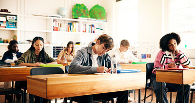 Buy stock photo Writing, education and students in classroom for college admission tests, thinking and quiz. Aptitude assessment, knowledge and academy with people in high school for lesson or scholarship exam