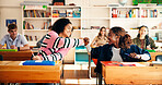 Fist bump, education and girls in classroom for college admission tests, smile and quiz. Aptitude assessment, celebration and academy with students in high school for lesson or scholarship exam