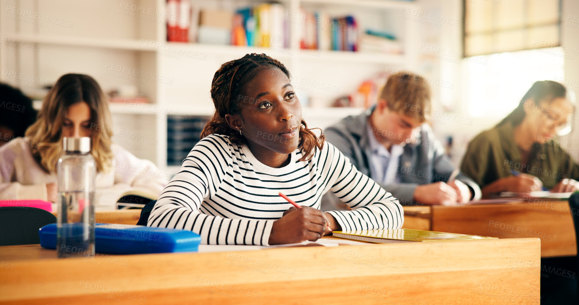 Buy stock photo Learning, classroom and girl writing notes in high school for test, education or academic knowledge. Teen students, lesson or study in academy for assessment, scholarship exam or quiz for development