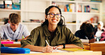 Education, classroom and happy teen writing in high school for test, learning or academic knowledge. Students, notes and girl study in academy for quiz, scholarship exam and portrait with glasses