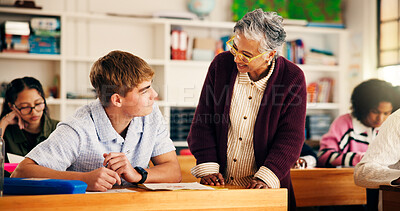 Buy stock photo Teacher, teen boy and talk in classroom for test, advice or tips for development at high school. Mature woman, pupil and smile for discussion, inspection or learning support for education at academy