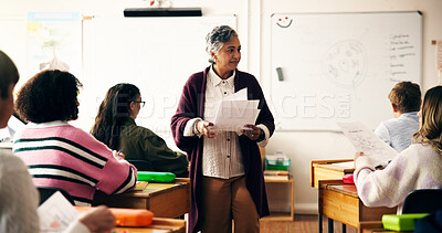 Buy stock photo Teacher, classroom and giving paper for test with teen pupil, group and results for science assessment. Mature woman, children and documents for exam, quiz and learning for education at high school