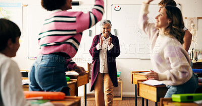 Buy stock photo Teacher, girl and applause for high five in classroom with goals, excited or celebration for test results. Mature woman, pupil and happy with success, grade announcement and achievement at school