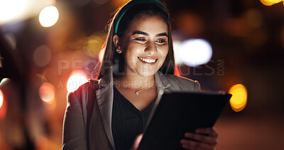 Buy stock photo Woman, tablet and happy in town at night, scroll or booking taxi for commute on business trip. Person, tech and chat in city, travel and notification with smile, app and social network in Mexico
