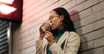 Thinking, woman and drinking coffee in city at night for travel, delayed date and waiting for taxi. Thoughts, female person and takeaway beverage, espresso and decision for commute reflection in town