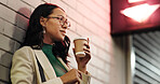 Businesswoman, coffee and reflection in city at night, thinking and memory with warm beverage on trip. Person, outdoor and perspective with insight, decision and inspiration with drink in Colombia