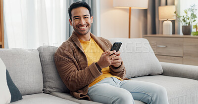 Buy stock photo Phone, portrait and smile with man on sofa in living room of home for social media scrolling. App, browsing and communication with happy person typing in apartment for internet search or text message