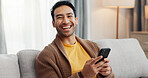 Laughing, phone and portrait with man on sofa in living room of home for social media scrolling. App, communication and funny with person typing in apartment for internet search or text message