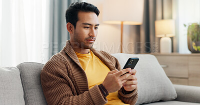 Buy stock photo Phone, reading and relax with man on sofa in living room of home for social media scrolling. App, communication and information with person typing in apartment for internet search or text message