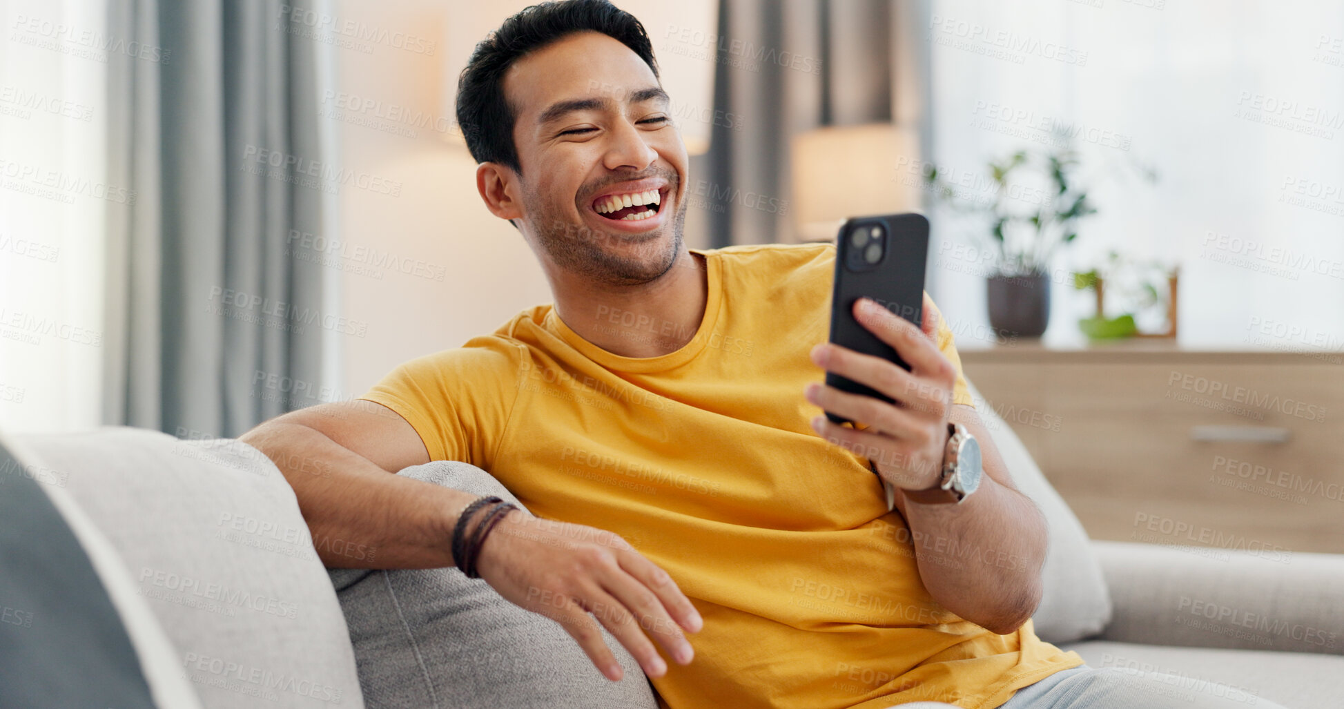 Buy stock photo Laugh, video call and man on sofa with phone for connection, social networking and online chat. Relax, home and person on smartphone for communication, internet and funny conversation on mobile app