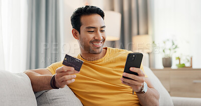 Buy stock photo Happy, credit card and man in home with phone for online shopping, digital purchase and payment. Sofa, house and person with debit info on smartphone for ecommerce, website sale and internet banking