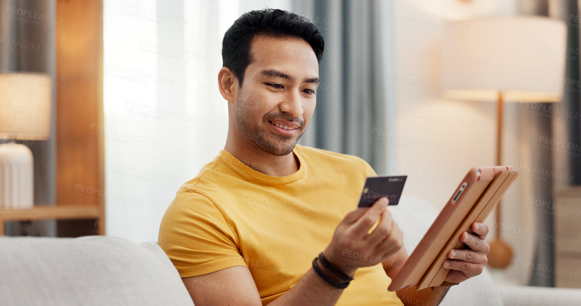 Buy stock photo Online shopping, credit card and man on tablet in home for digital purchase, payment and subscription. Happy, relax and person with debit info on tech for ecommerce, website sale and internet banking