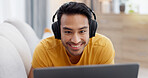 Relax, laptop and headphones with man on sofa for streaming service, smile and film. Movie subscription, media website and home cinema app with person in living room of apartment for online video
