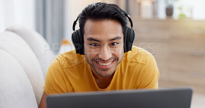 Buy stock photo Relax, laptop and headphones with man on sofa for streaming service, smile and film. Movie subscription, media website and home cinema app with person in living room of apartment for online video