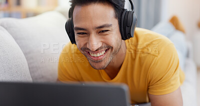 Buy stock photo Relax, laptop and smile with man on sofa for streaming service, headphones and film. Movie subscription, media website and home cinema app with person in living room of apartment for online video