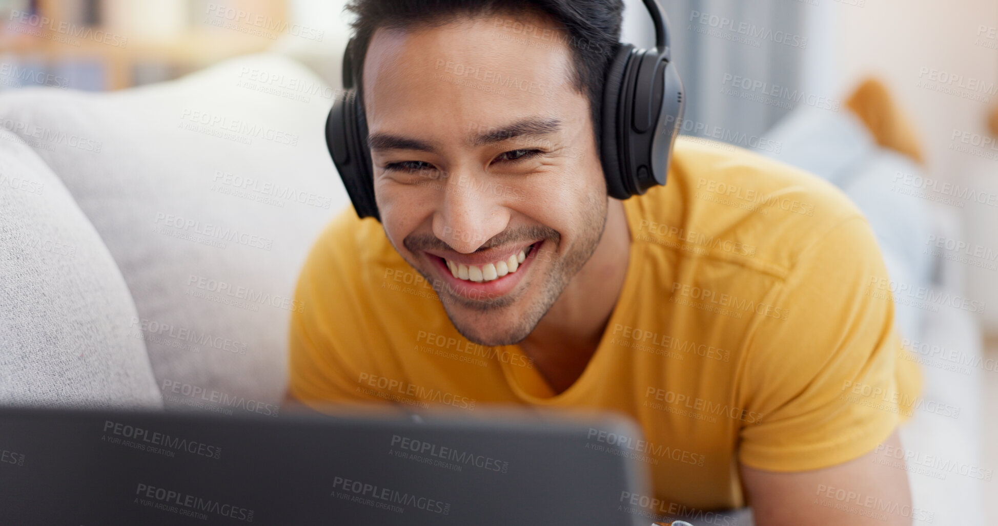 Buy stock photo Relax, laptop and smile with man on sofa for streaming service, headphones and film. Movie subscription, media website and home cinema app with person in living room of apartment for online video