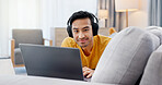Relax, laptop and portrait with man on sofa for streaming service, headphones and film. Movie subscription, media website and home cinema app with person in living room of apartment for online video