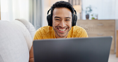 Buy stock photo Man, laptop and headphones on sofa for social media, movie and video streaming or website in home. Smile, internet audio and happy person on couch with technology, break and watching film on app