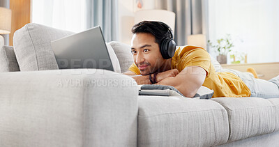 Buy stock photo Relax, laptop and movie with man on sofa for streaming service, headphones and film. Digital subscription, media website and home cinema app with person in living room of apartment for online video