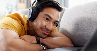 Buy stock photo Smile, headphones and laptop with man on sofa for streaming service, film website and comfortable. Movie subscription, watching series and entertainment with person in living room of home for search