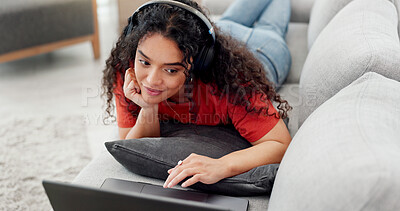 Buy stock photo Headphones, laptop and subscription with woman on sofa in living room of home for watching online. Computer, relax and video streaming with person in apartment for break, entertainment or media
