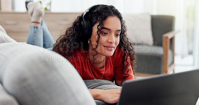 Buy stock photo Happy, headphones and laptop with woman on sofa for streaming service, film website or comfortable. Movie subscription, watching series and entertainment with person in living room of home for search