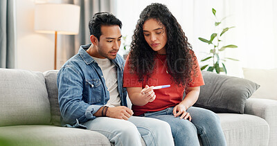 Buy stock photo Pregnancy test, home and couple waiting on sofa unsure for fertility doubt, results and parenting news. Relationship, pregnant and man with woman with medical kit for ivf treatment or ovulation