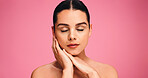 Face, skincare and wellness with woman on studio space for cosmetics or dermatology results. Aesthetic, beauty and relax with model, touching skin, isolated on pink background for satisfaction