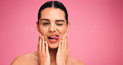 Buy stock photo Woman, portrait and skincare in studio, funny face and tongue out with results on pink background. Girl, model and touch with wink, mockup space and facial transformation with beauty in Portugal