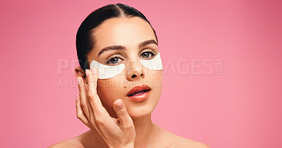 Buy stock photo Portrait, woman and eye mask for beauty in studio for dark circle, reduce puffiness and hydration. Person, facial patches and mockup space for skincare, collagen benefits and shine on pink background