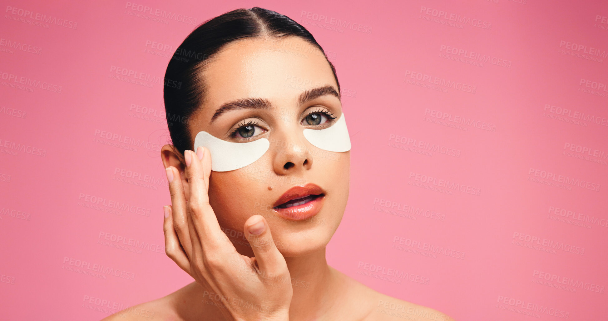 Buy stock photo Portrait, woman and eye mask for beauty in studio for dark circle, reduce puffiness and hydration. Person, facial patches and mockup space for skincare, collagen benefits and shine on pink background