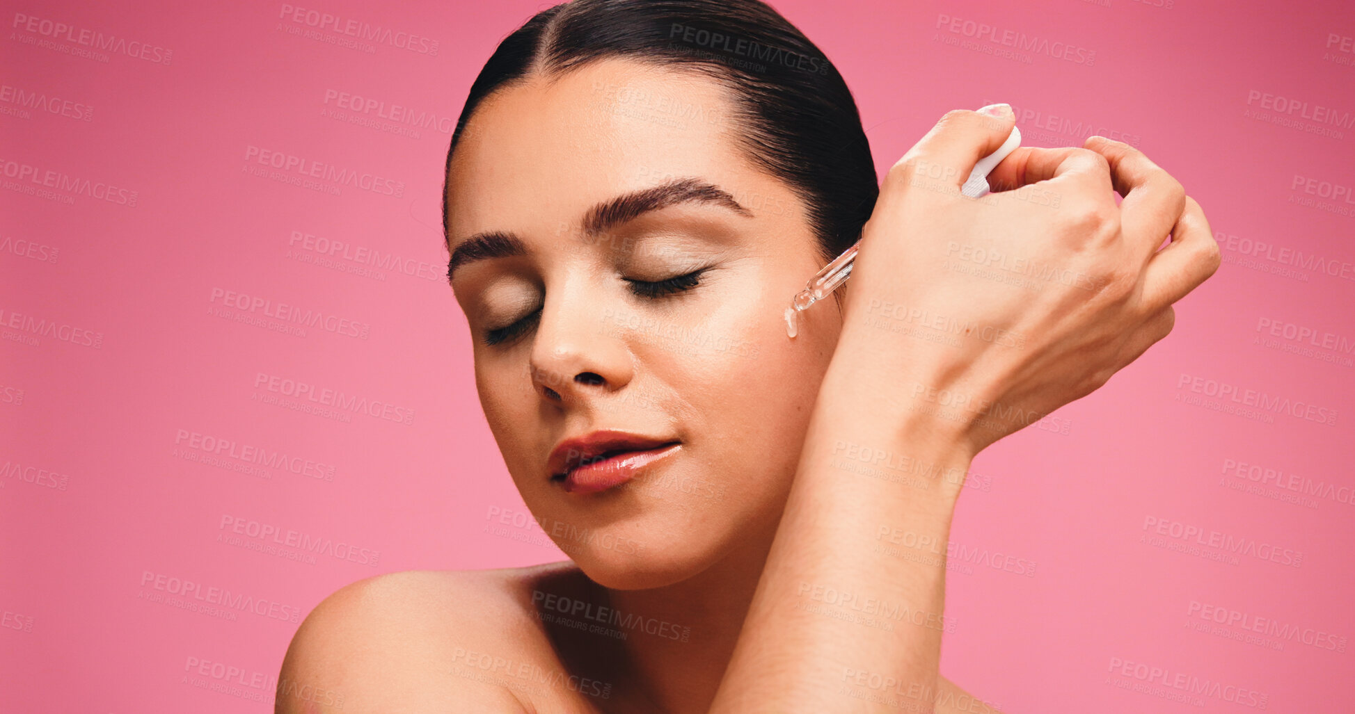 Buy stock photo Woman, dropper and oil for skincare in studio with space, application and beauty on pink background. Girl, model and cosmetics product for benefits with hyaluronic acid, collagen and dermatology