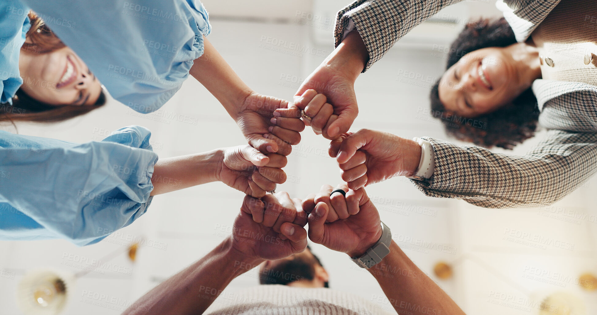 Buy stock photo Hands, fist bump and team in office with circle, low angle and happy for support with goal at company. People, group and smile at startup for celebration, success or collaboration at creative agency
