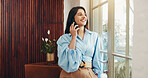 Phone call, window and business woman in office for communication, contact and online chat. Startup, creative company and person on smartphone for connection, discussion or networking for client deal