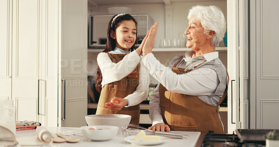 Buy stock photo Happy grandmother, grandchild and high five in kitchen for baking success or dessert recipe in home. Grandma, grandkid and smile with ingredients or apron for culinary art, skill or learning together