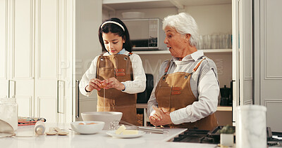 Buy stock photo Baking, egg and child with grandmother in kitchen for teaching, bonding or development. Happy, learning and girl kid with senior woman for preparing dessert, cake or cookies together in home.
