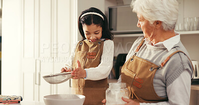 Buy stock photo Baking, flour and kid with grandmother in kitchen for teaching, bonding or development. Happy, learning and girl child with senior woman for preparing dessert, cake or cookies together in home.