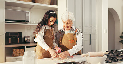 Buy stock photo Girl, grandmother and help with cookies in kitchen, learning and development with bonding at home. People, grandma and child for teaching, baking or smile with cooking, guide and food at family house