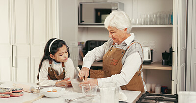 Buy stock photo Baking, ingredients and child with grandmother in kitchen for teaching, bonding or development. Happy, learning and girl kid with senior woman for preparing dessert, cake or cookies together in home.